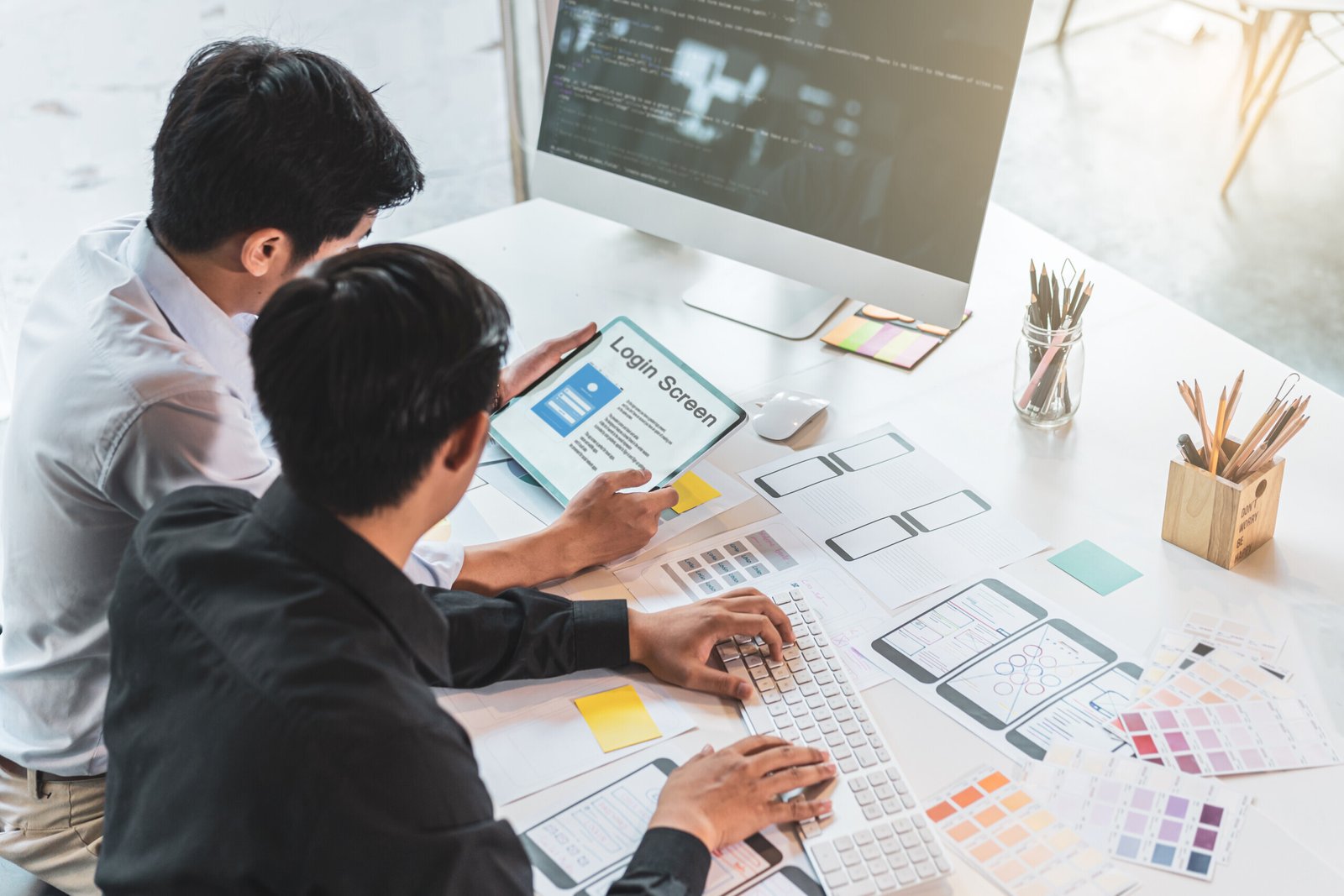 Cropped shot of startup UX UI front end designers drawing responsive web content or mobile app with graphics tablet.UX team designers sketching prototype and wireframe layout.